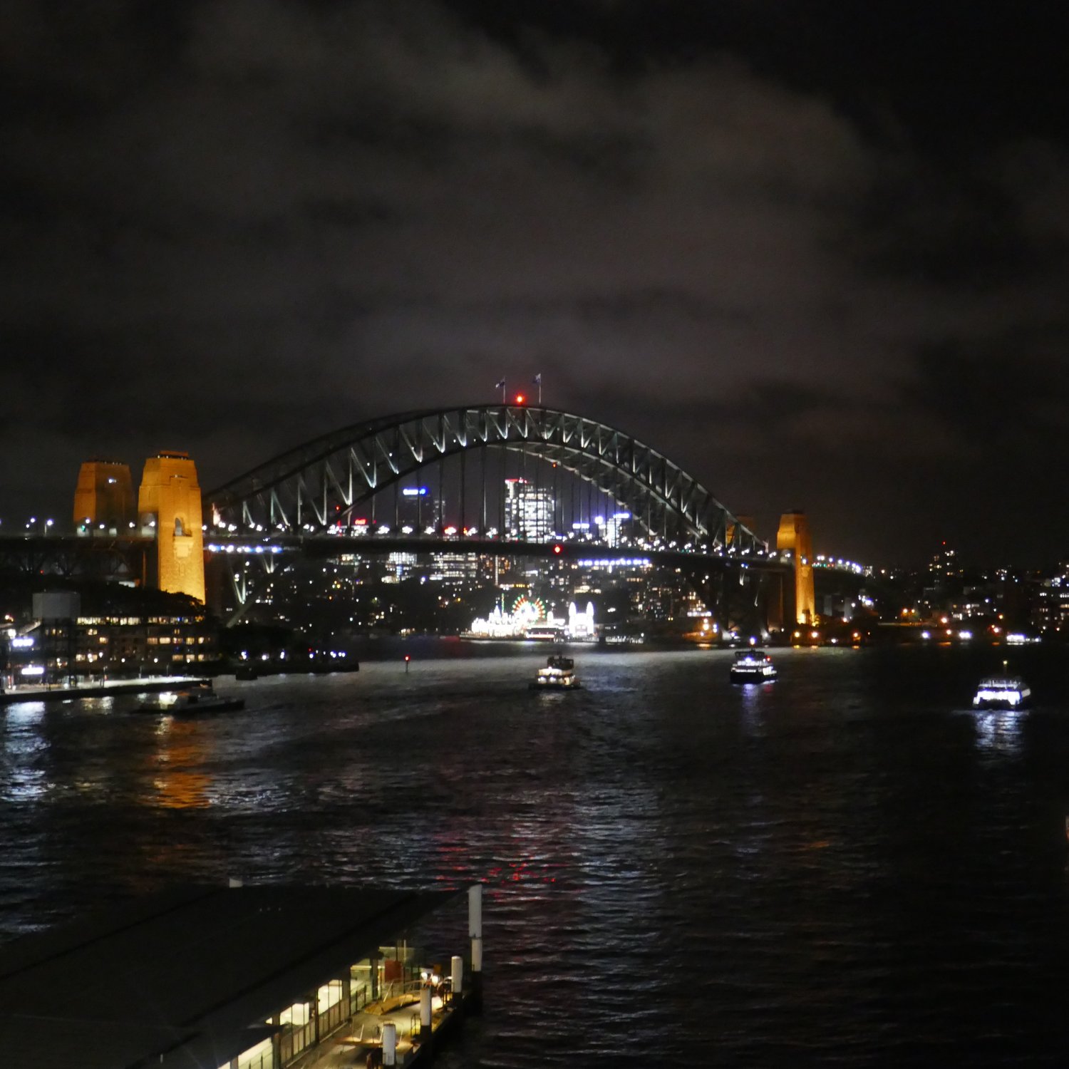 A night view of the Sydney Harbour Bridge, as seen from the Cahill Bridge Walkway, above the Circular Quay Train Station