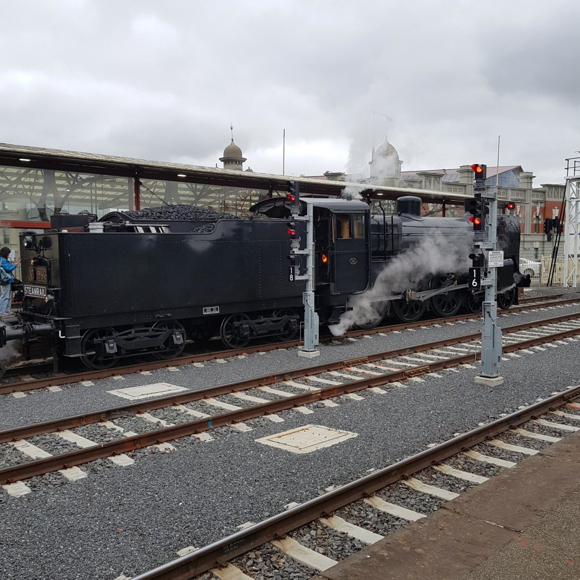 And image of Steamrail A2 986 stopped outside the Great Train Hall at Ballarat, with the Ballarat Provincial Hotel barely visible through the steam, in the background