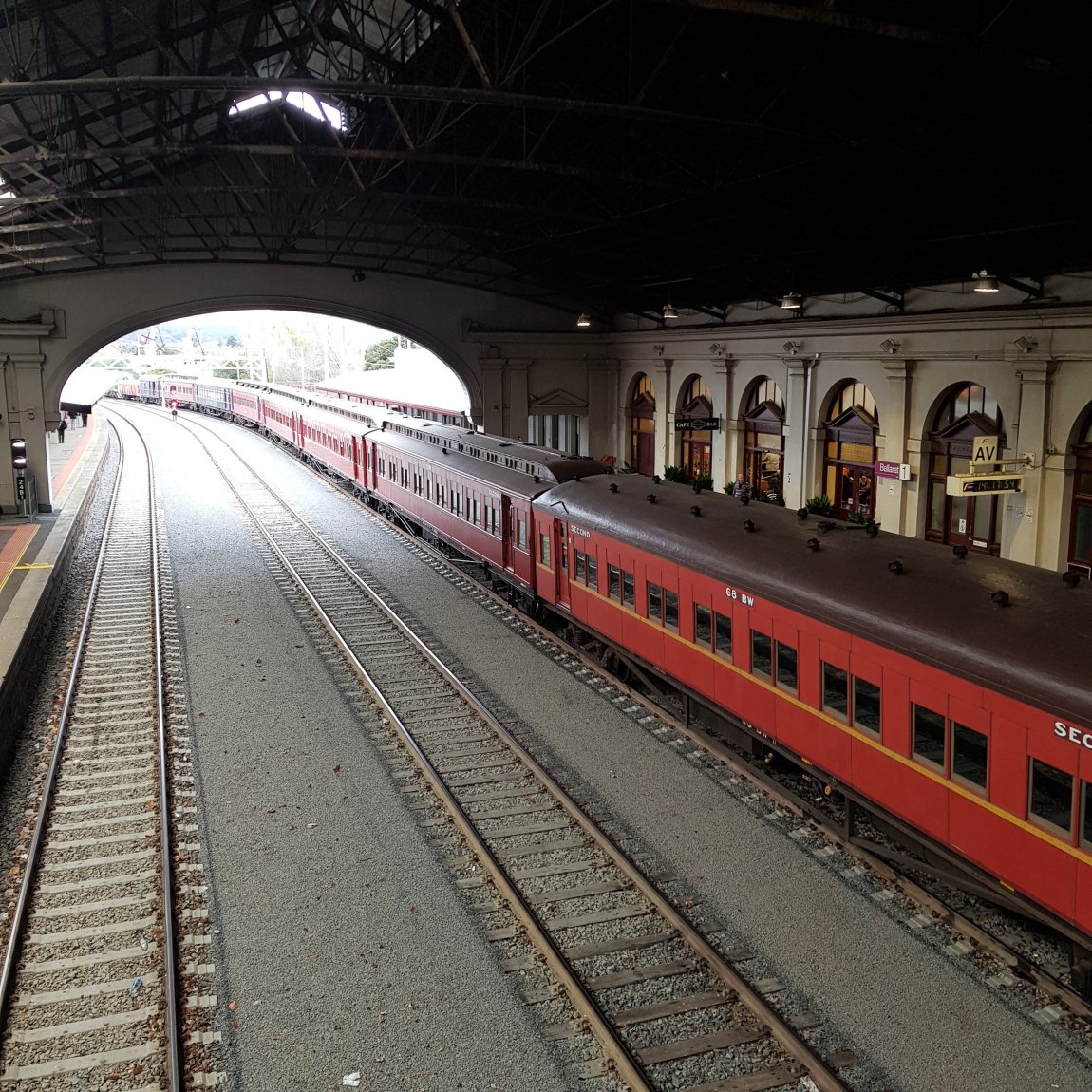 Image of Steamrail passenger carriages, stopped inside the Great Train Hall at Ballarat, directly outside of the Refreshment Rooms