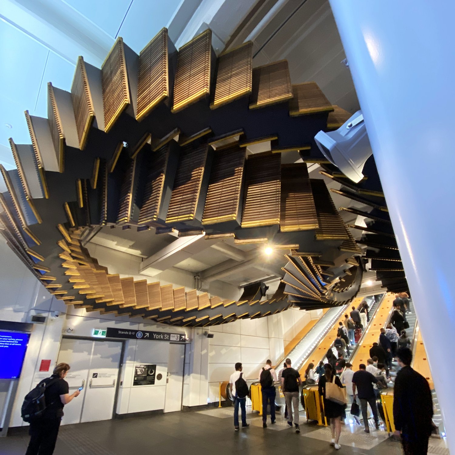 Image of Interloop sculpture, made up of wooden escalator treads, at Wynyard Station