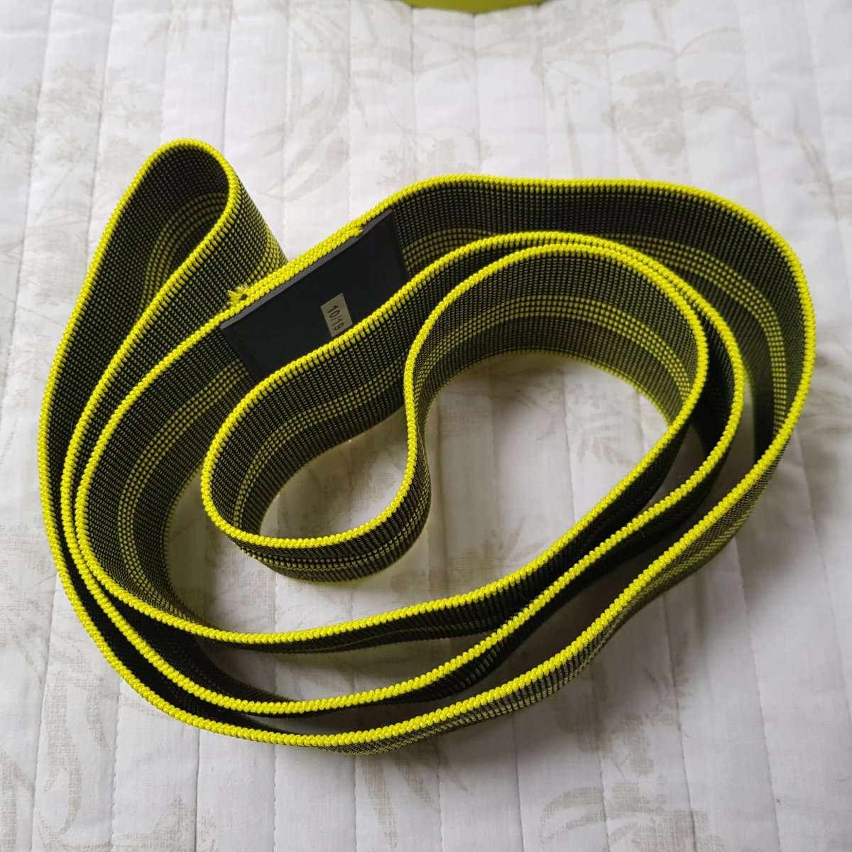 Combination of four images of resistance bands, ranging from simple large band, to more complex stirrup band