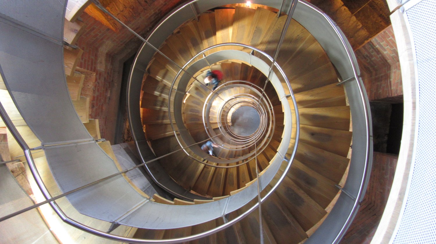 Combination of two images of the staircase at Glasgow's Lighthouse Centre Macintosh Building; one looking up from the bottom, the other looking down from the top