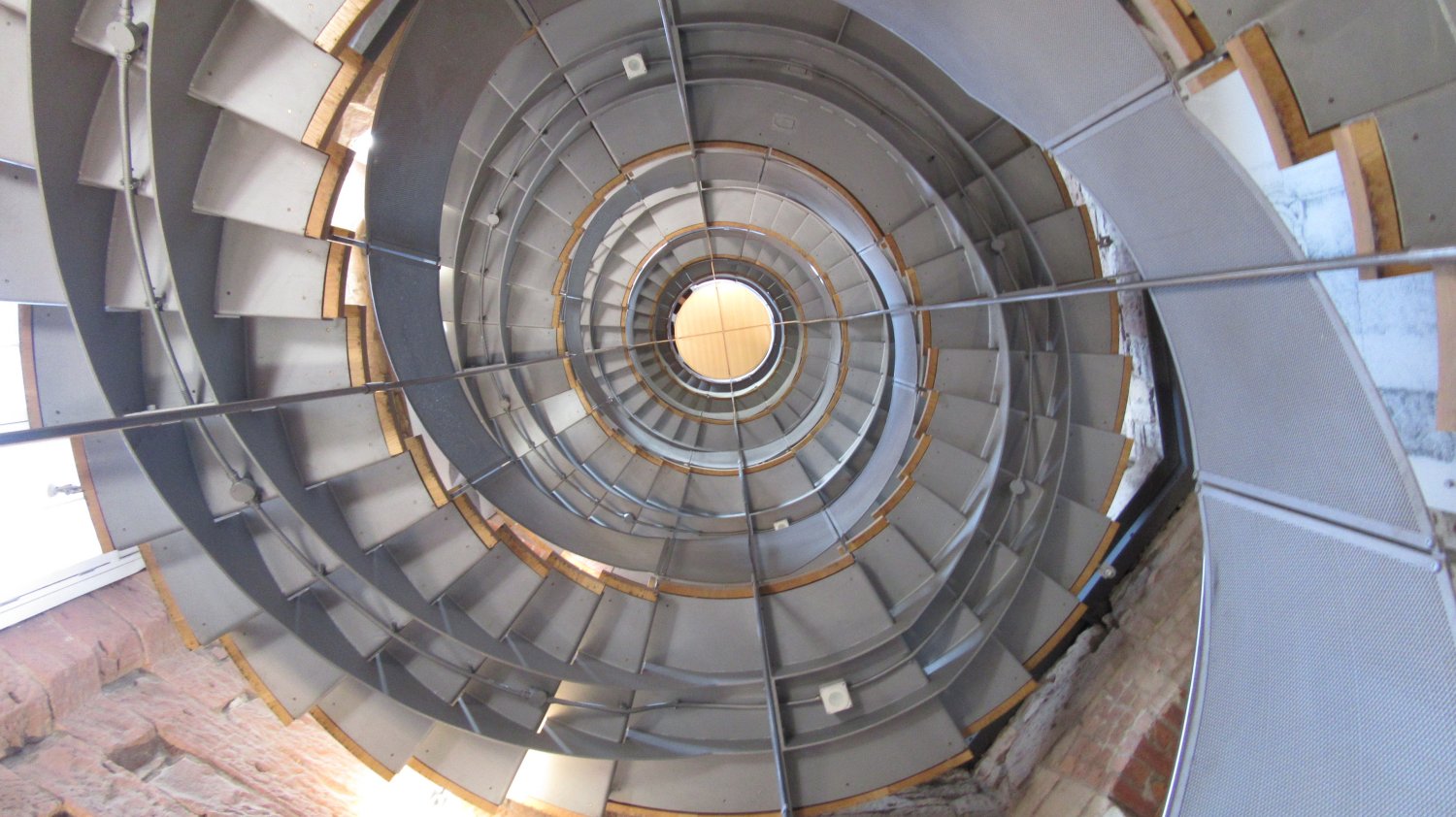 Combination of two images of the staircase at Glasgow's Lighthouse Centre Macintosh Building; one looking up from the bottom, the other looking down from the top