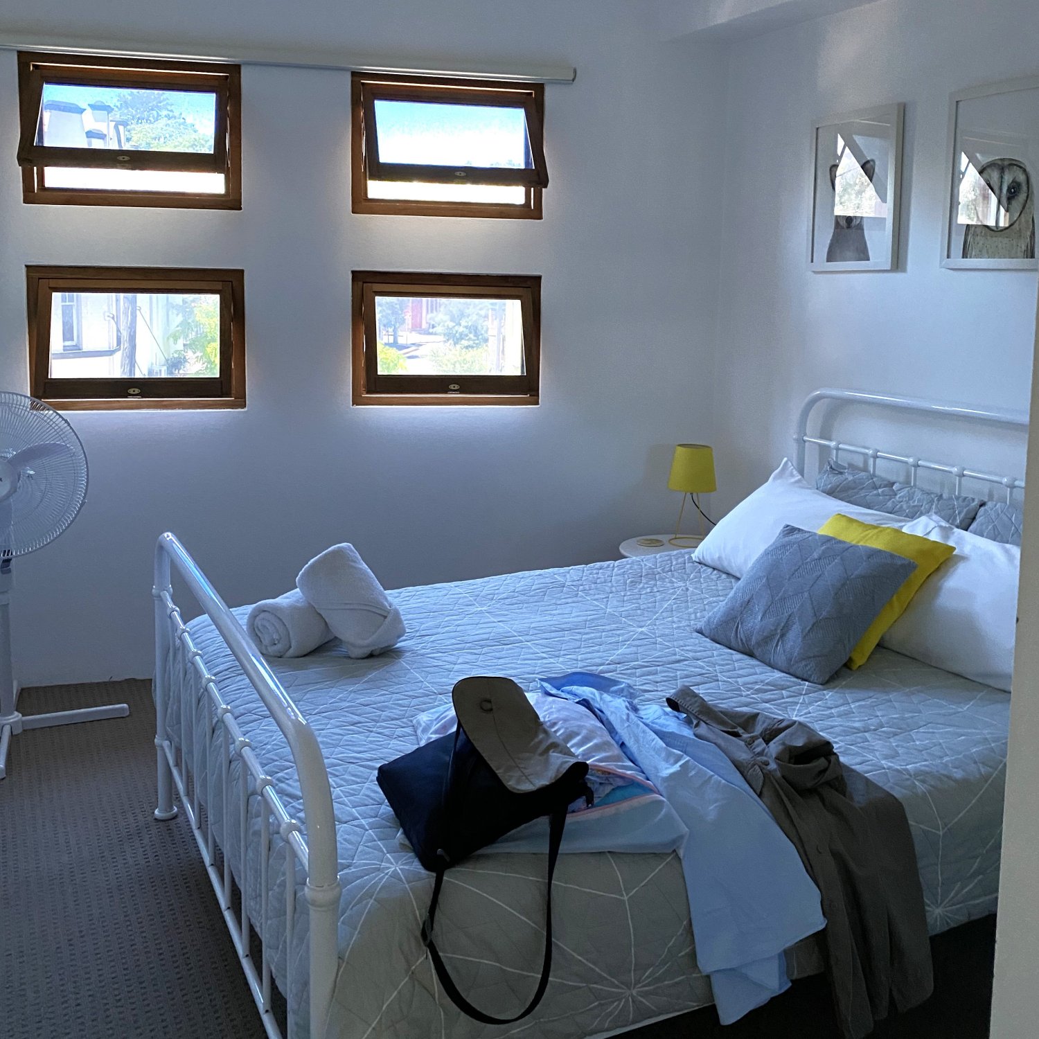 view of a bedroom with four small, tinted external windows