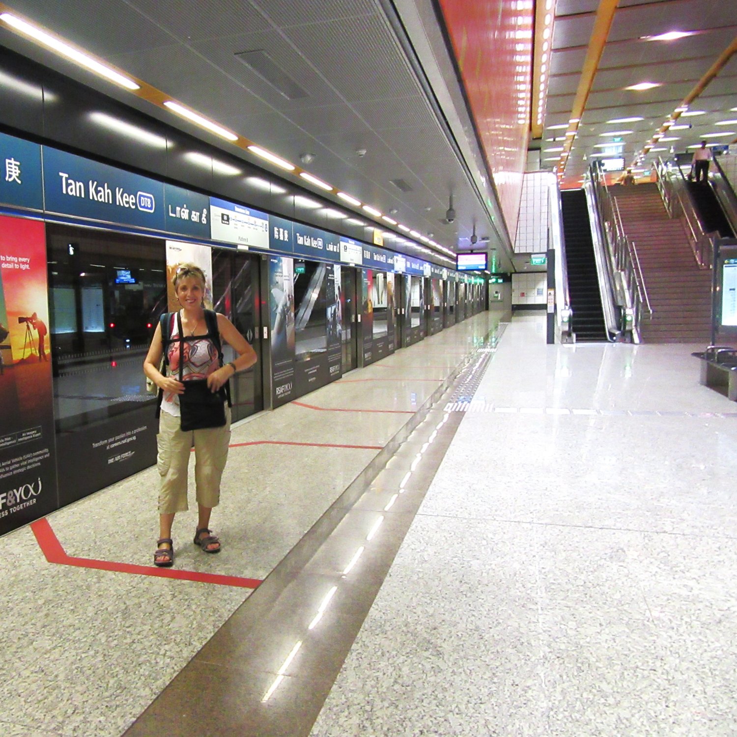 image shows Marlene about to board an MRT (Mass Rapid Transit) train to Singapore's Changi Airport