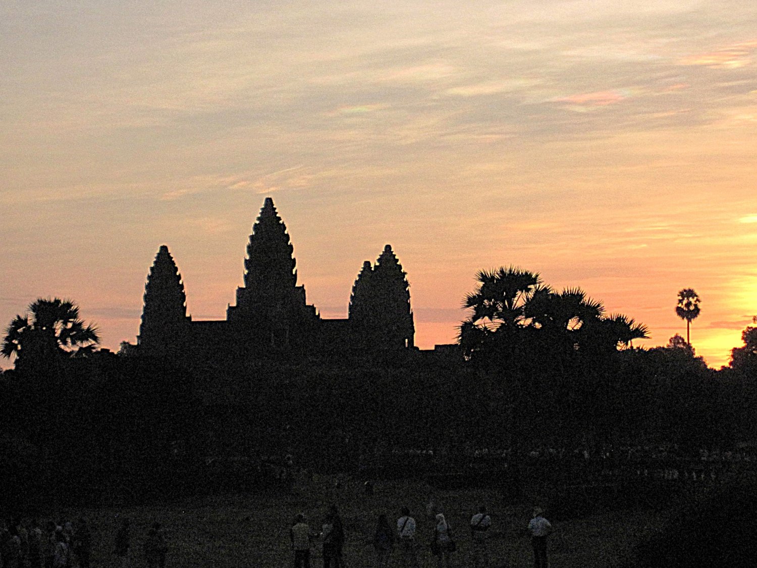 Image of Angkor Wat temple silhouetted against the morning sky at sunrise