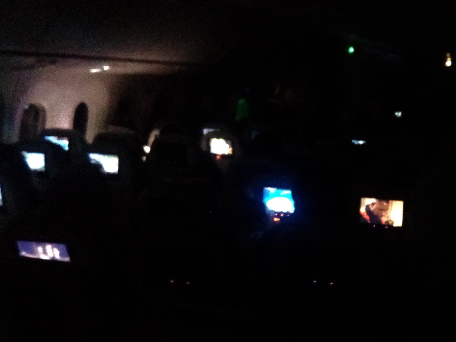 Image showing the darkened cabin of RBA's Dreamliner, with a number of entertainment screens clearly visible