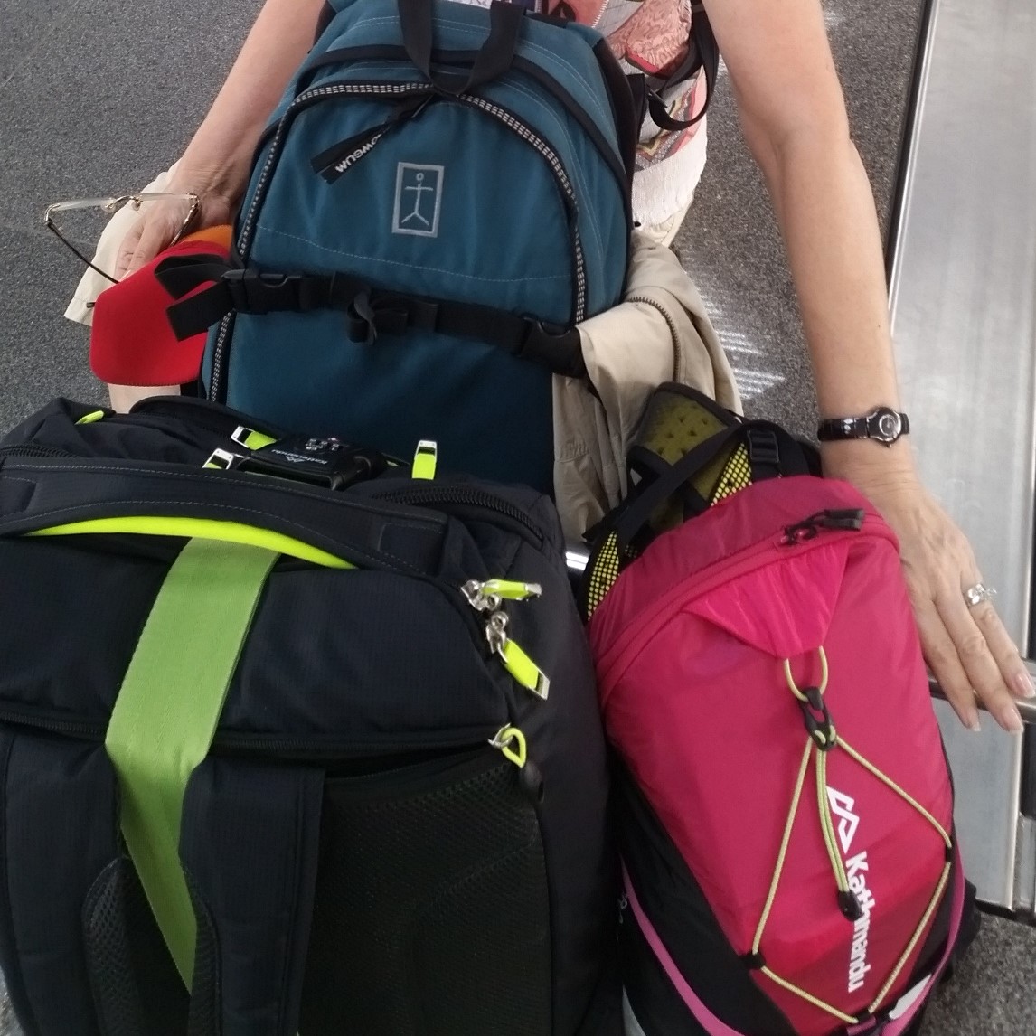 image showing paasenger collectiong several bags from the luggage claim carousel at Singapore's Changi Airport