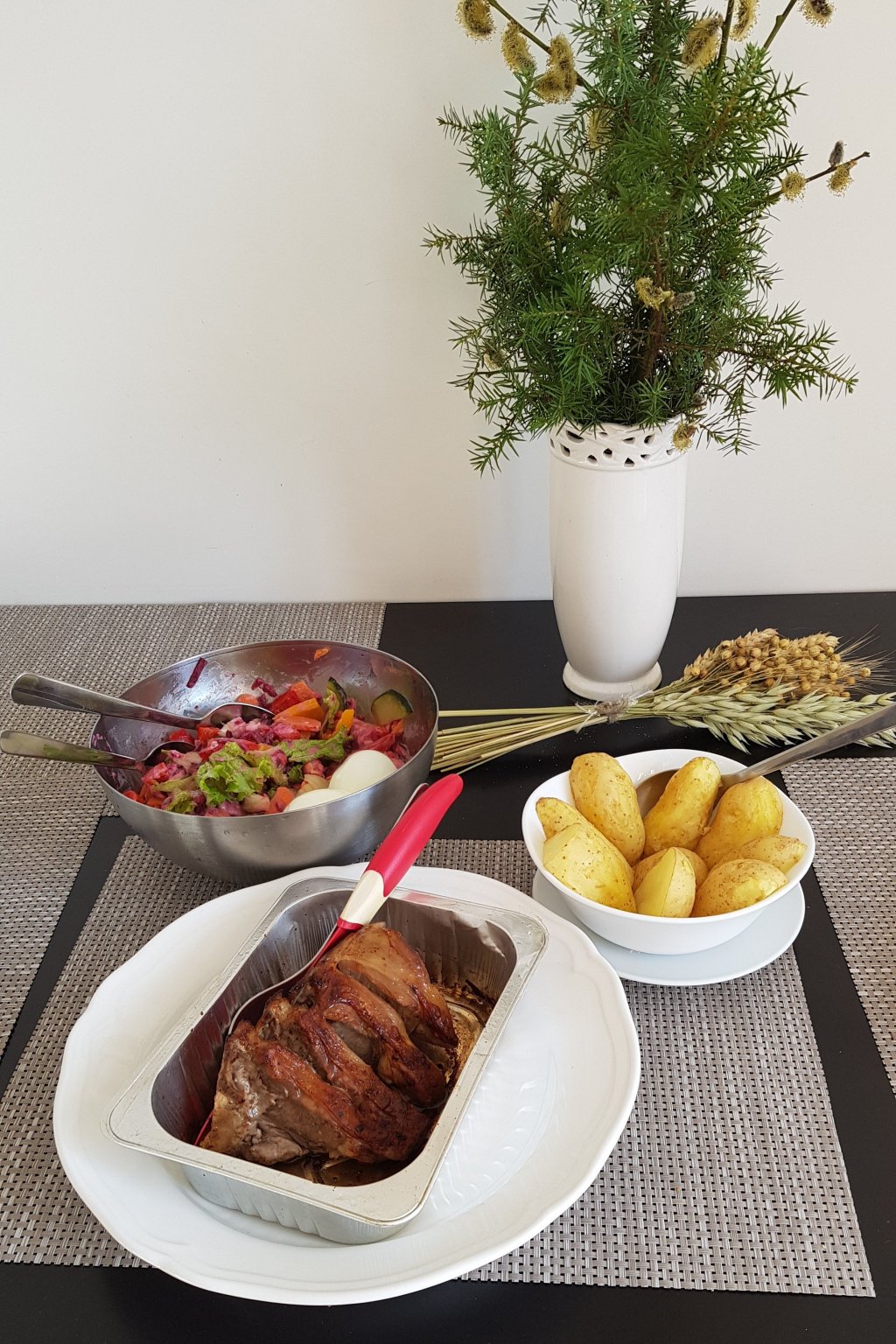 image showing a cooked meal - roast pork, roast potatoes, mixed salad - all collected in the Vilnius market