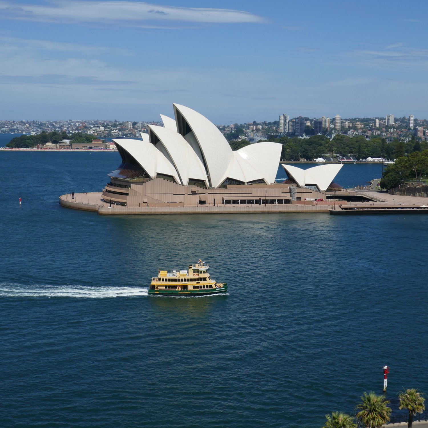 image showing an elevated view of the Sydney Opera House, taken from the walkway on the Sydney Harbour Bridge, with a First Fleet class ferry in the foreground