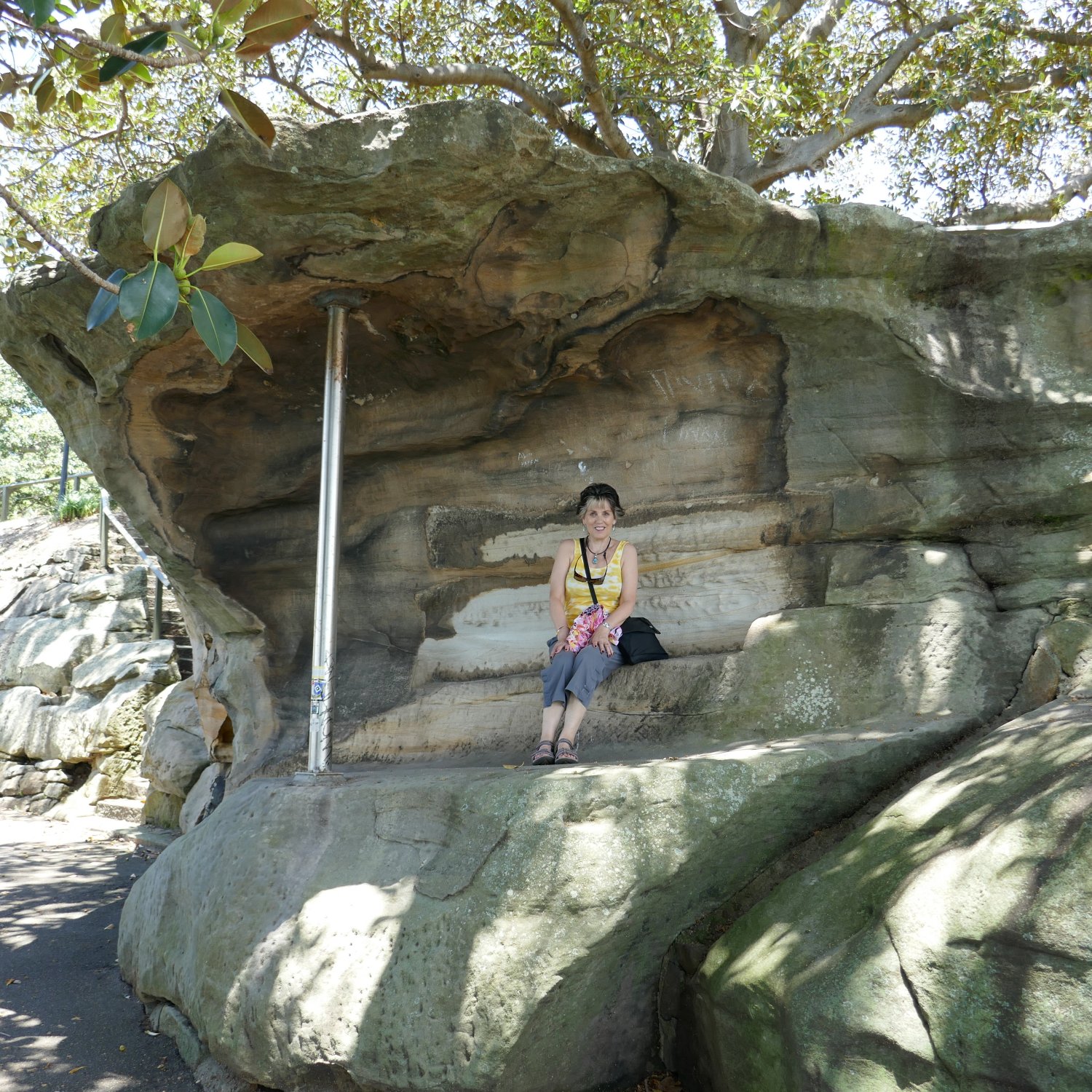 image showing Marlene sitting in a rock shelter near to Mrs Macquarie's Chair