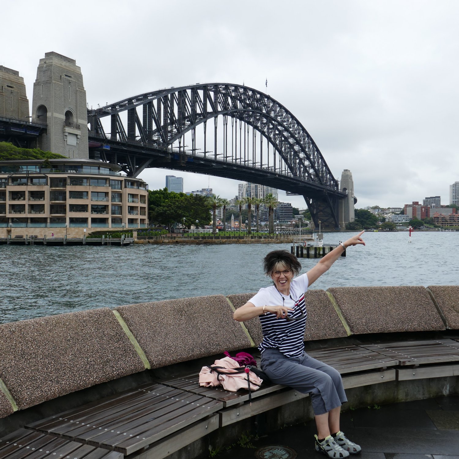 image of Marlene sitting at the Circular Quay Harbour Lookout, beside the Overseas Passenger Terminal, on the corner of the Quay and Campbell’s Cove