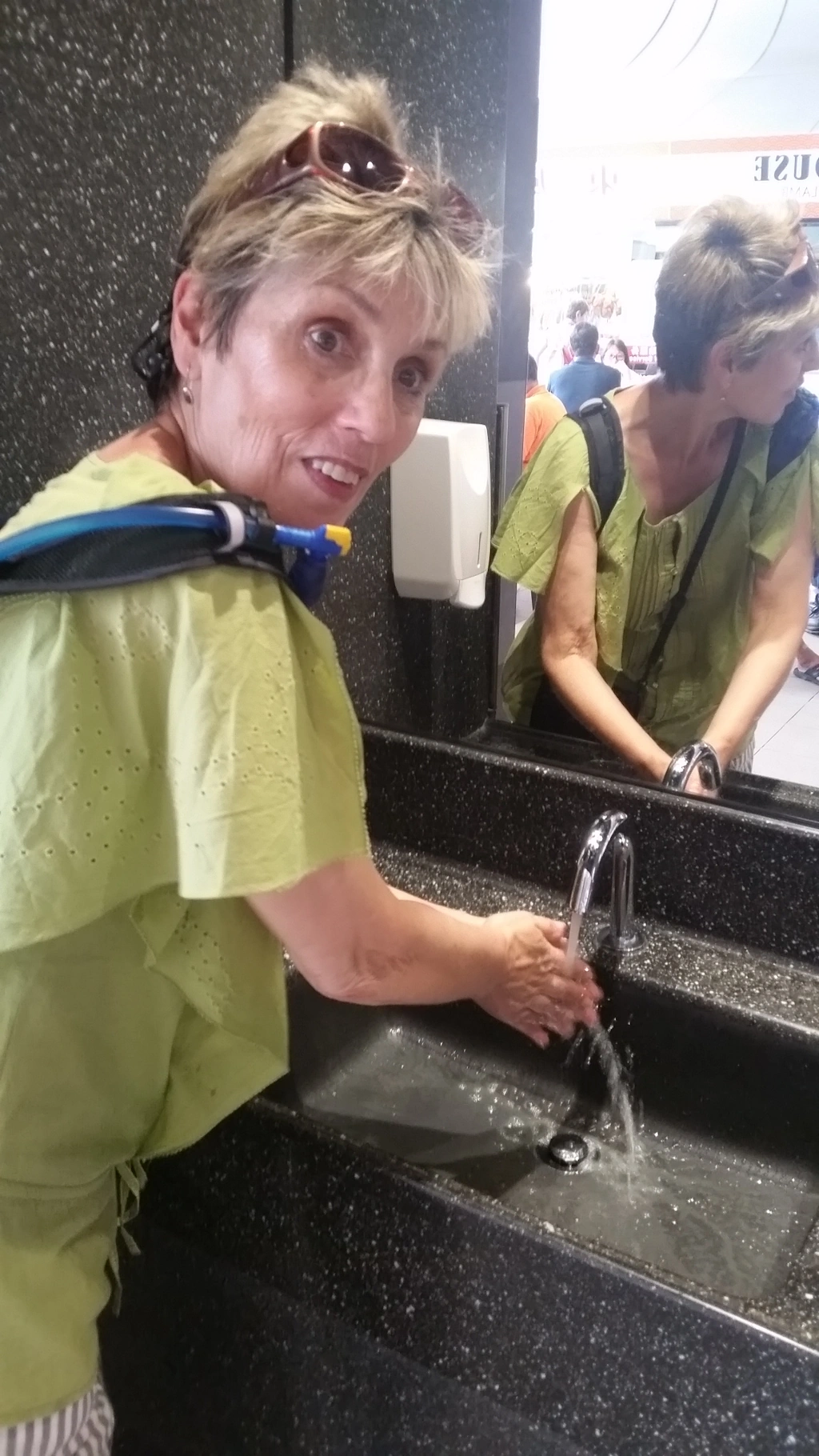 image of Marlene washing her hands at Singapore's Adam Road Food Centre