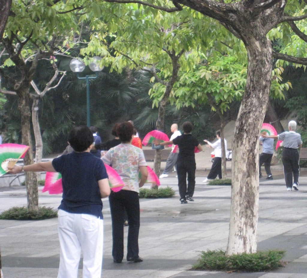 image shows a group of senior-aged women doing Tai Chi fan exercises in Hong Kong