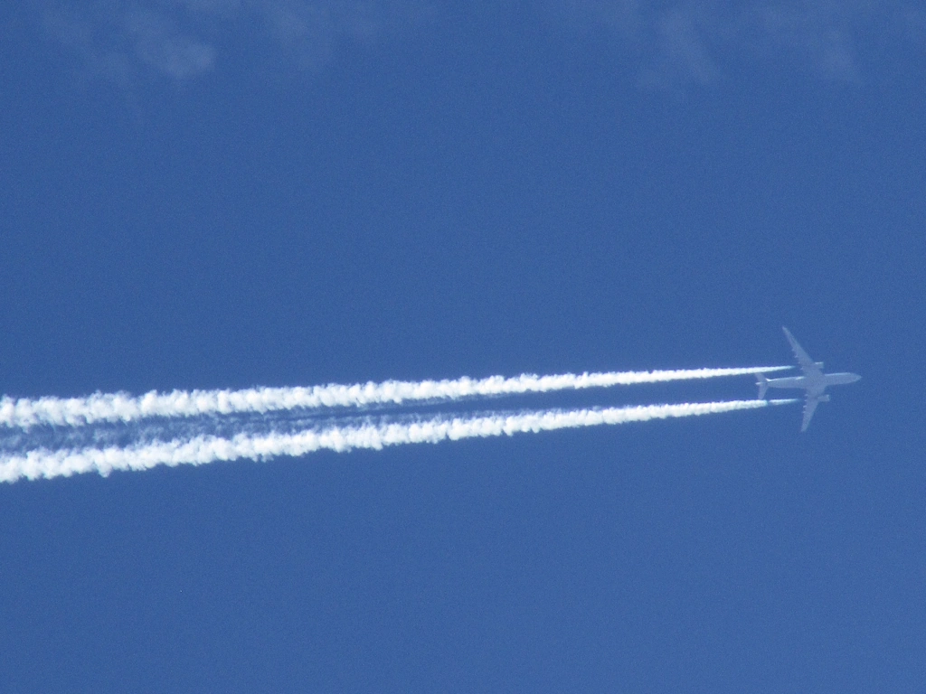 Image of jet airplane making contrails high in the sky over Vilnius, Lithuania