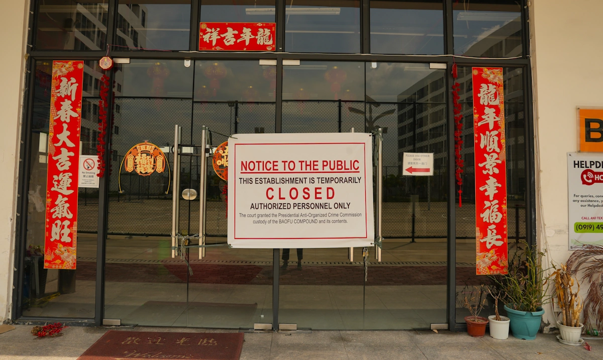 Image showing a "closed" sign at the entrance to a complex in Bamban, north of Manila, which had operated as a 'scam farm' - Credit: UN Office on Drugs and Crime
